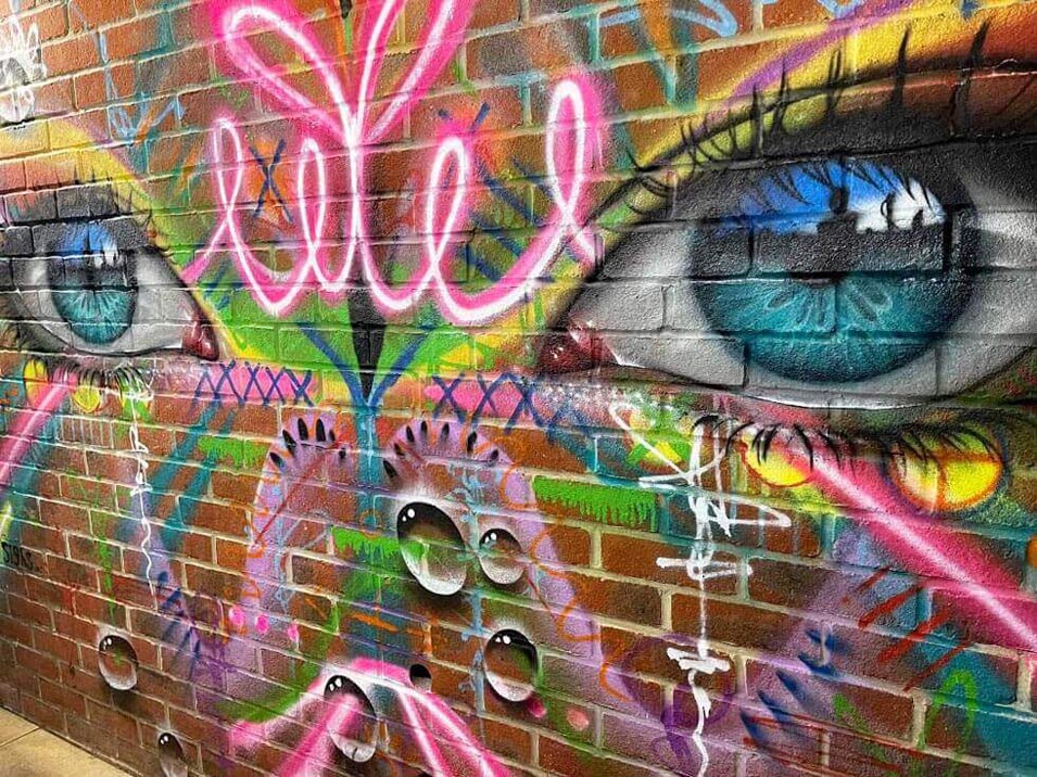 My Dog Sighs artwork painted on a bar wall in Southsea